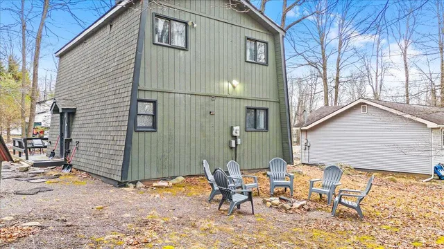 a backyard of a house with table and chairs