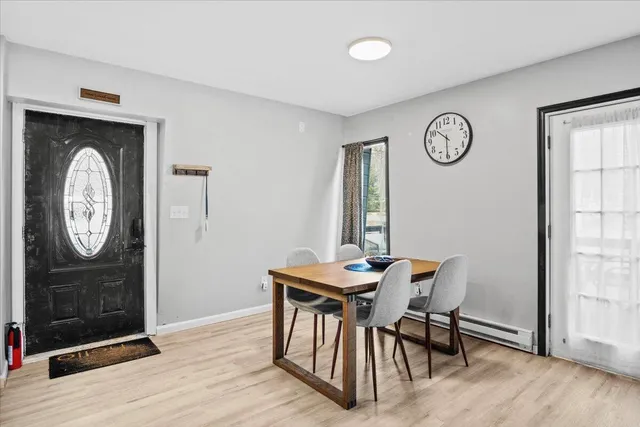 a view of a dining area with furniture window and wooden floor