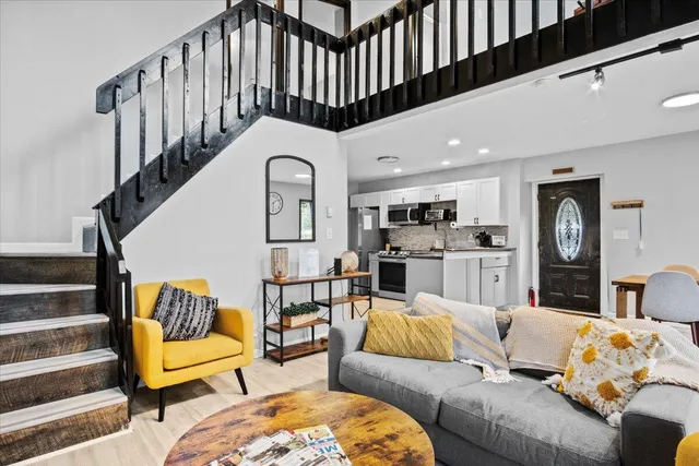 a living room with furniture ceiling fan and a rug