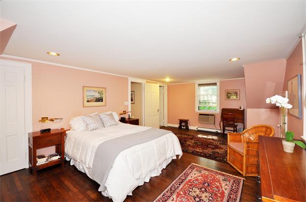 75 Blake Road Brookline, MA 02445 - Photo 11 of 21 a spacious bedroom with a bed a dresser and wooden floor