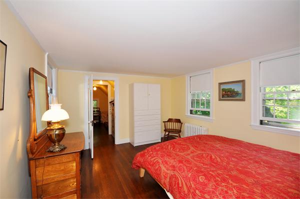 75 Blake Road Brookline, MA 02445 - Photo 14 of 21 a bedroom with a bed and a dresser next to a window