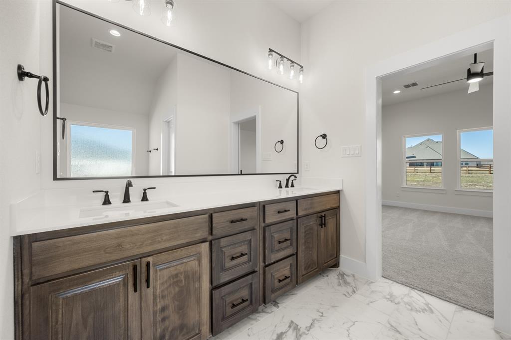 4867 Prairie Sky Lane DISH, TX 76247 - Photo 23 of 27 a bathroom with double vanity sink and a mirror
