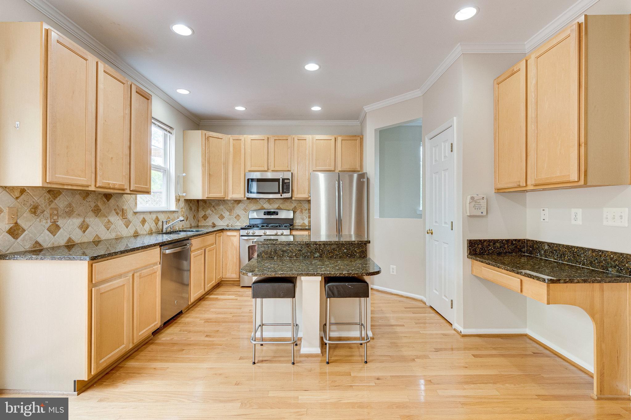 43146 Huntsman Square Broadlands, VA 20148 - Photo 14 of 31 Kitchen with center island and bar stools