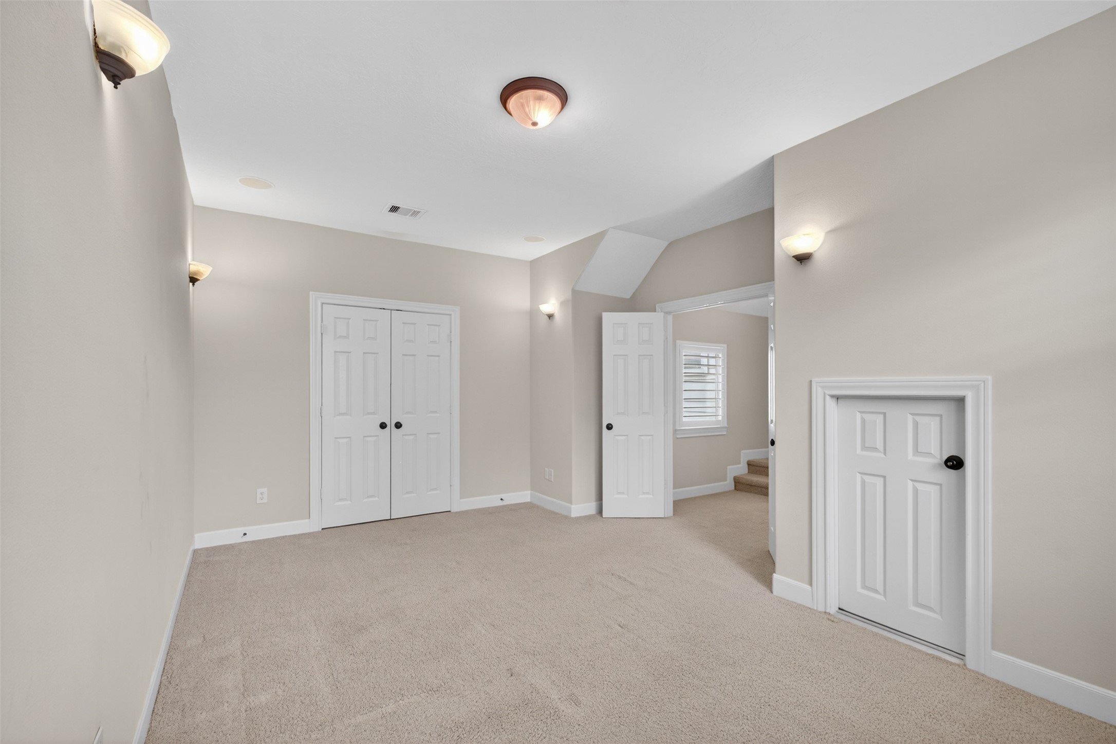 7303 Starry Night Katy, TX 77494 - Photo 29 of 42 This bonus room is on a separate wing of the home with walk in attic storage and a nice French door storage closet.