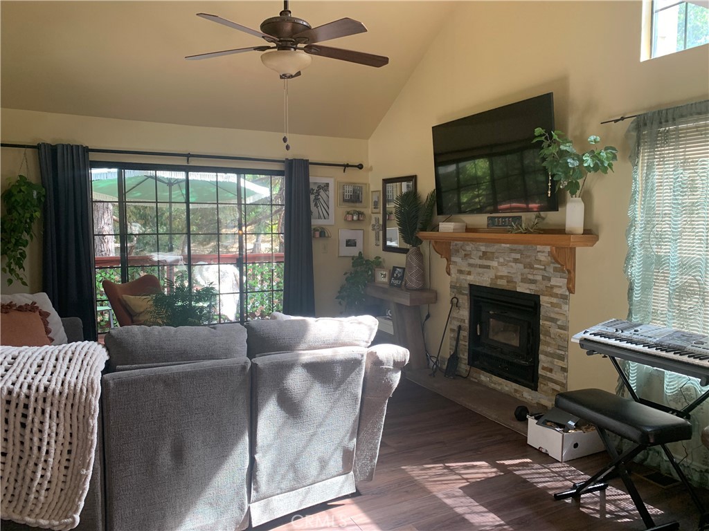 40513 Saddleback Road Bass Lake, CA 93604 - Photo 7 of 11 a living room with furniture a flat screen tv and a fireplace
