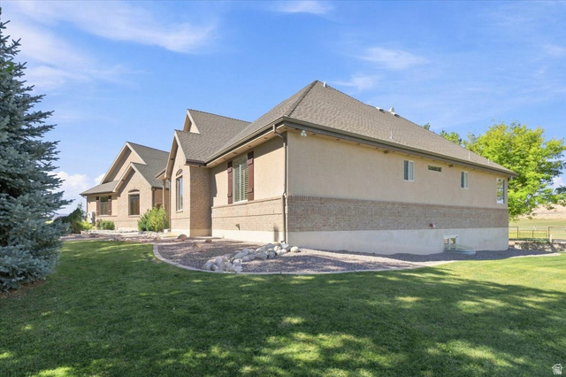 11290 South Southfield Road Mayfield, UT 84643 - Photo 19 of 103 Expansive exterior featuring a stucco and brick facade, multiple gables, a shingled roof, and a mature evergreen tree