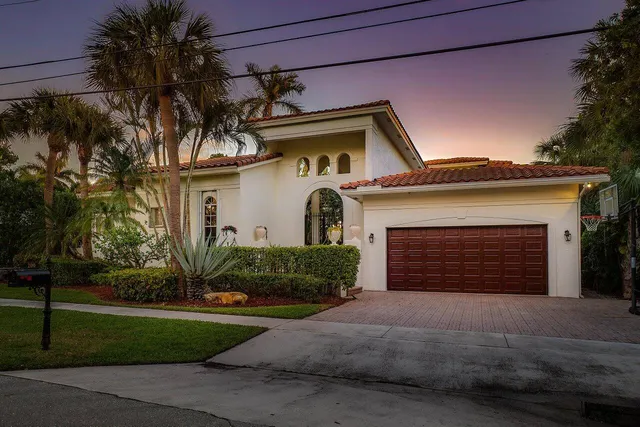 a front view of a house with a garden