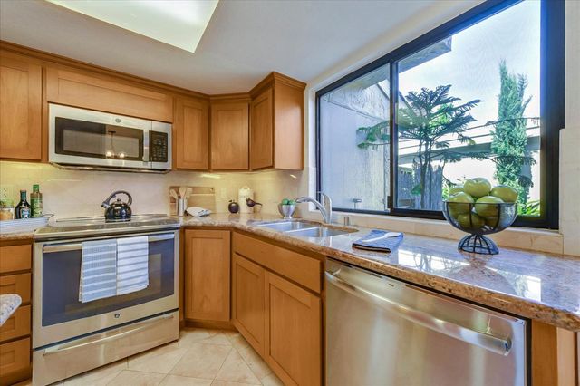 a dining room with furniture a chandelier and wooden floor
