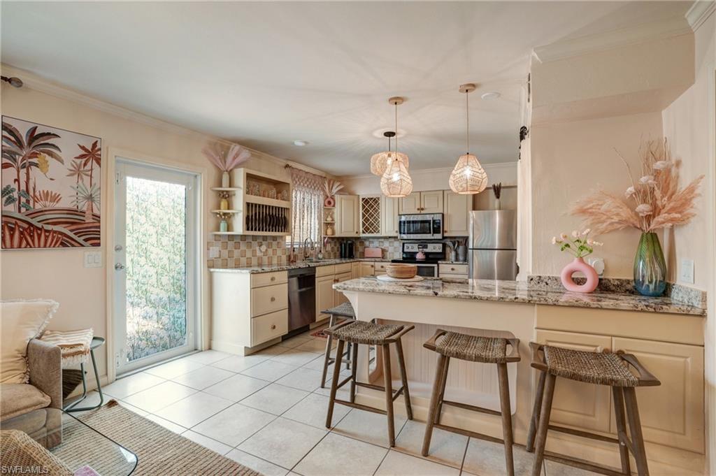 7146 Congdon Road Fort Myers, FL 33908 - Photo 19 of 50 a kitchen with stainless steel appliances kitchen island granite countertop a sink and cabinets