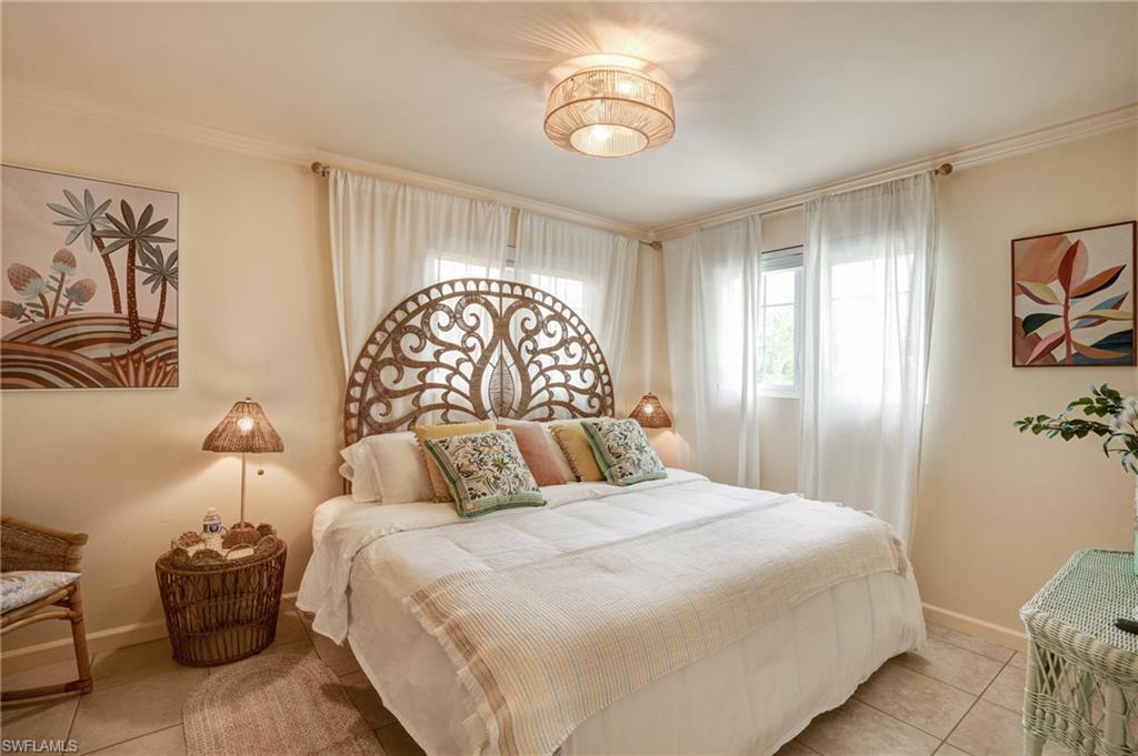 7146 Congdon Road Fort Myers, FL 33908 - Photo 20 of 50 a bedroom with a bed and a chandelier