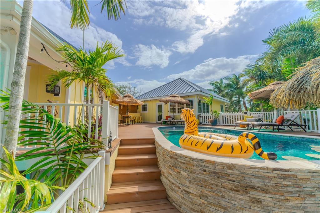 7146 Congdon Road Fort Myers, FL 33908 - Photo 27 of 50 a view of a swimming pool with a lounge chairs