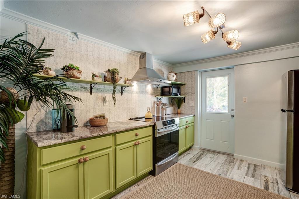 7146 Congdon Road Fort Myers, FL 33908 - Photo 29 of 50 a kitchen with stainless steel appliances granite countertop a sink a stove and a refrigerator