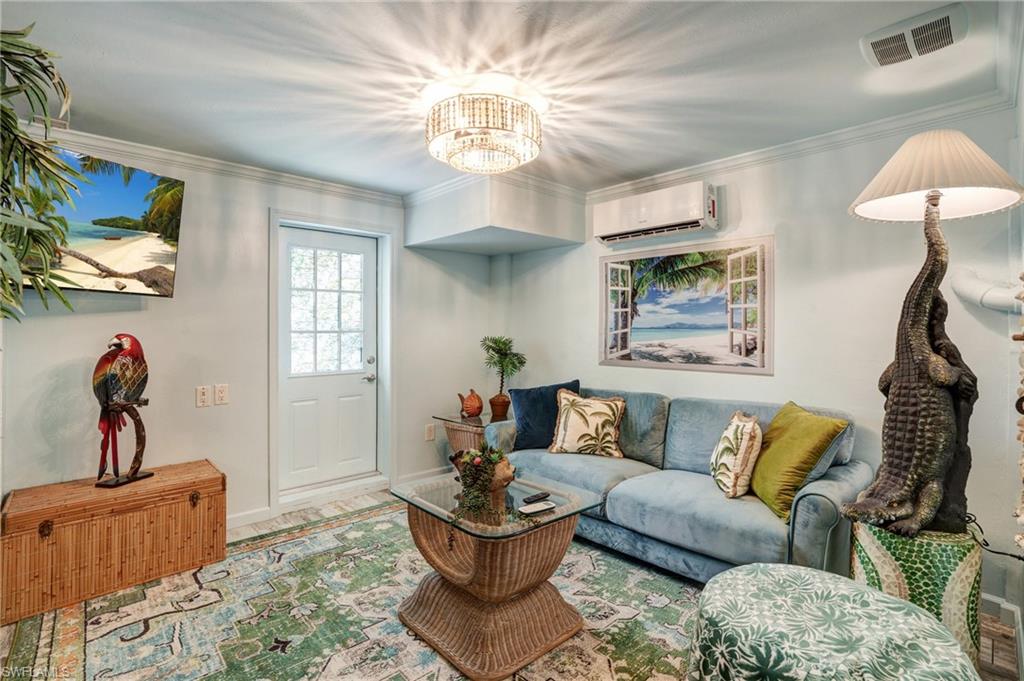 7146 Congdon Road Fort Myers, FL 33908 - Photo 30 of 50 a living room with furniture a window and a chandelier