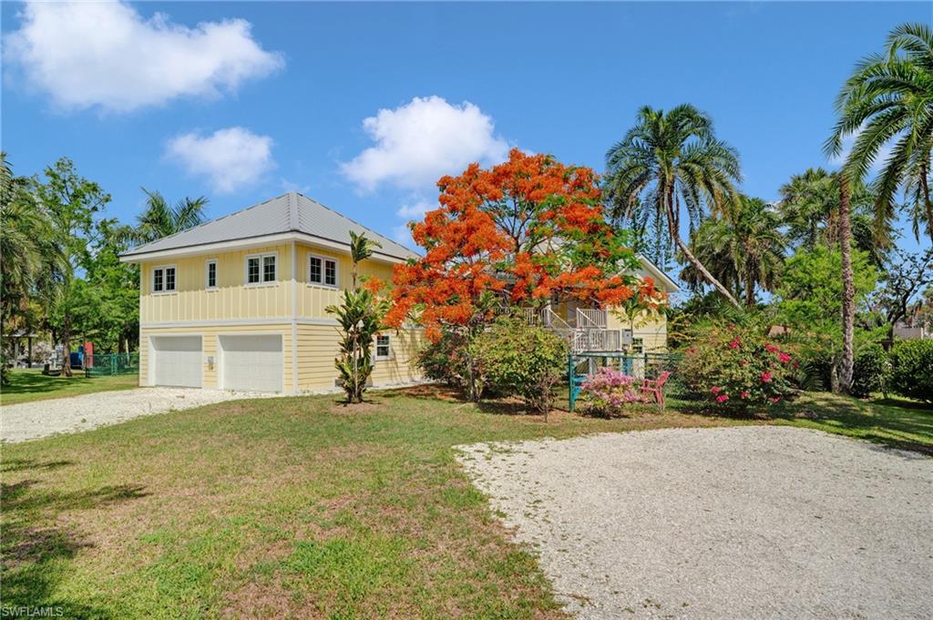 7146 Congdon Road Fort Myers, FL 33908 - Photo 3 of 50 a front view of a house with a yard