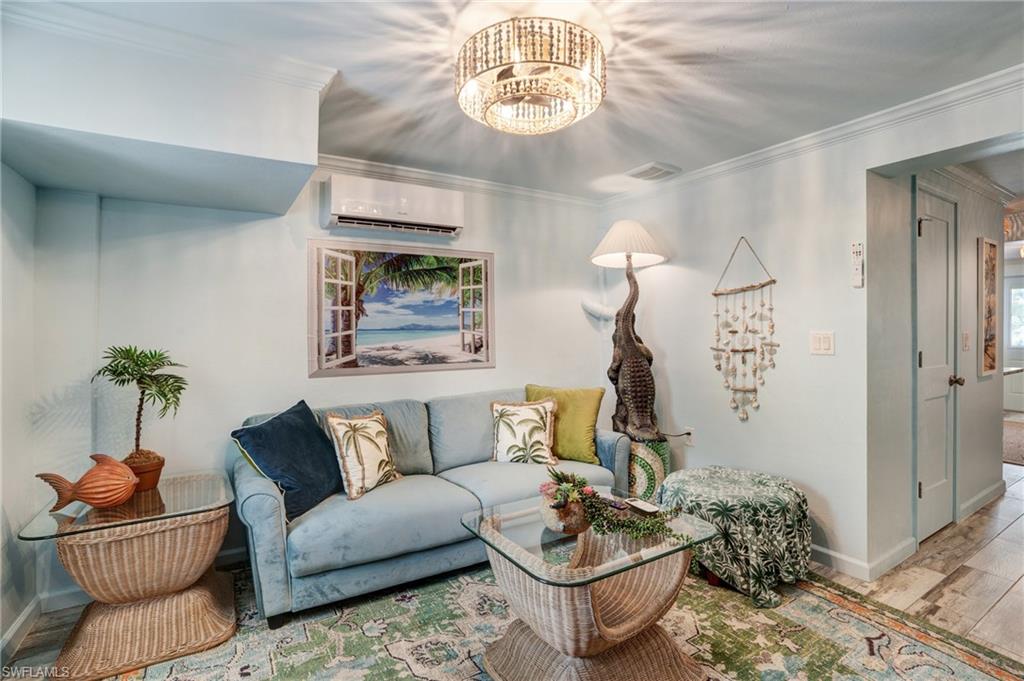 7146 Congdon Road Fort Myers, FL 33908 - Photo 32 of 50 a living room with furniture and a chandelier