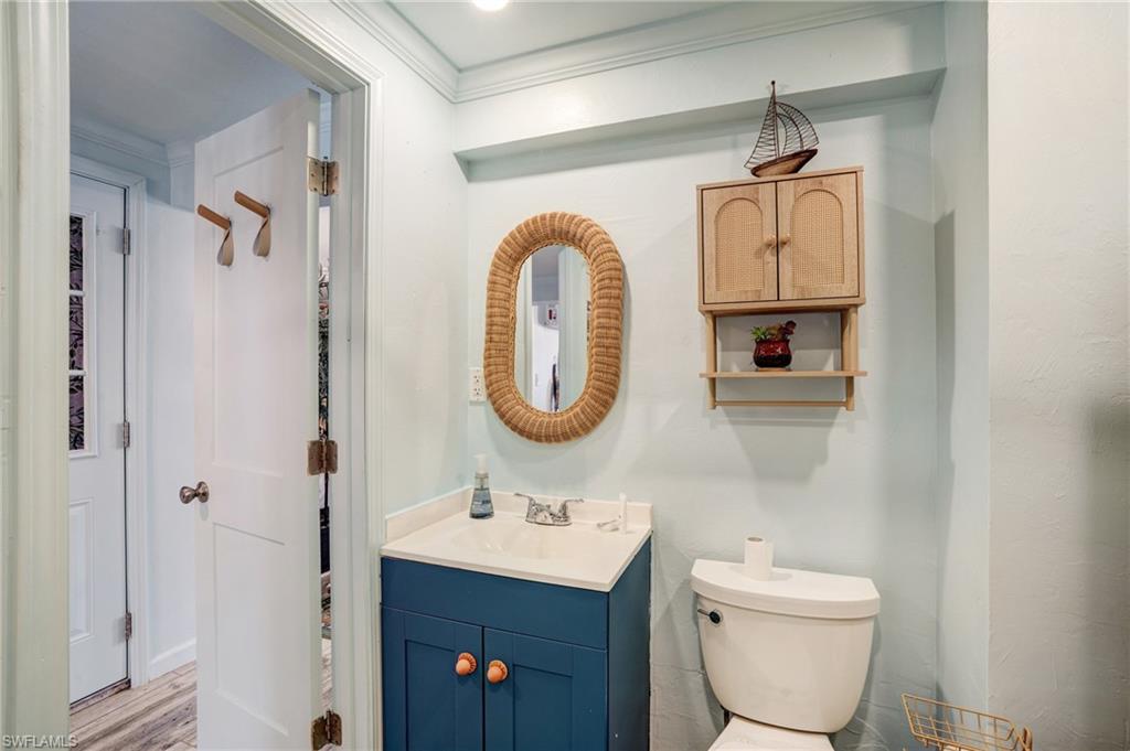 7146 Congdon Road Fort Myers, FL 33908 - Photo 34 of 50 a bathroom with a toilet a sink and a mirror