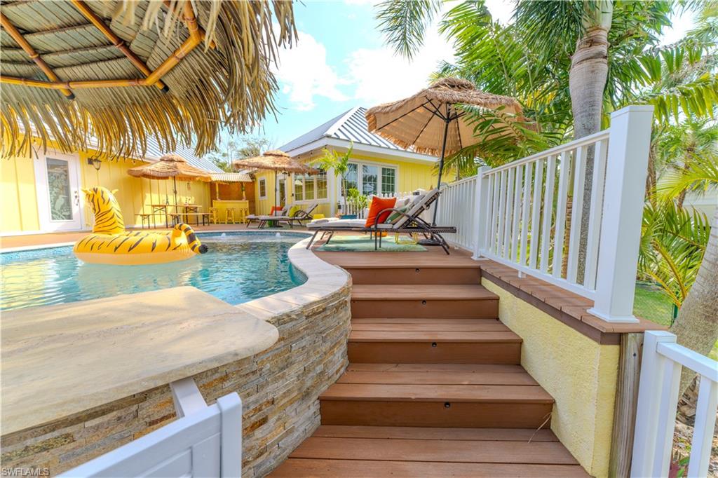 7146 Congdon Road Fort Myers, FL 33908 - Photo 38 of 50 a view of a patio with chairs and umbrellas on a sidewalk