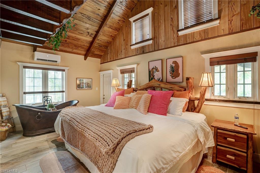 7146 Congdon Road Fort Myers, FL 33908 - Photo 7 of 50 a bedroom with a bed a dresser next to a window