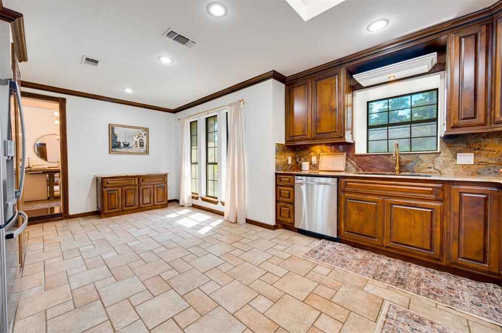 650 Spruce Drive Reno, TX 75462 - Photo 12 of 29 a view of a kitchen with stainless steel appliances granite countertop a refrigerator and a stove top oven