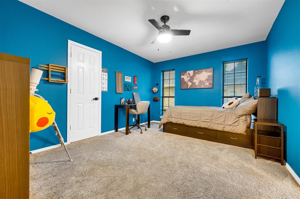 650 Spruce Drive Reno, TX 75462 - Photo 18 of 29 a bedroom with a bed and a chandelier