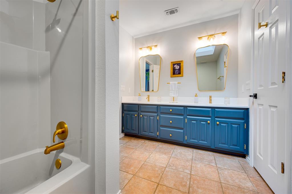 650 Spruce Drive Reno, TX 75462 - Photo 19 of 29 a bathroom with a granite countertop sink and a mirror