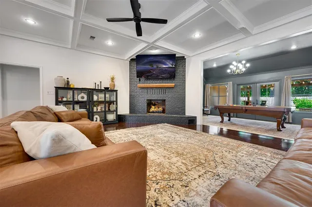 a living room with furniture flat screen tv and a fireplace