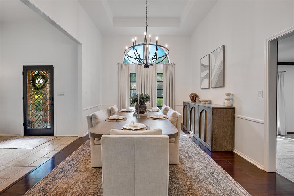 650 Spruce Drive Reno, TX 75462 - Photo 7 of 29 a dining room with wooden floor a chandelier a wooden table and chairs