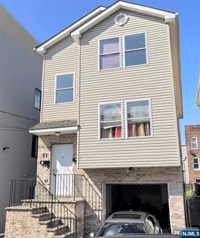 51 Godwin Avenue Paterson, NJ 07501 - Photo 1 of 14 a front view of a house with a balcony
