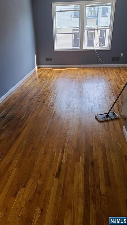 51 Godwin Avenue Paterson, NJ 07501 - Photo 3 of 14 a view of empty room with wooden floor and fan