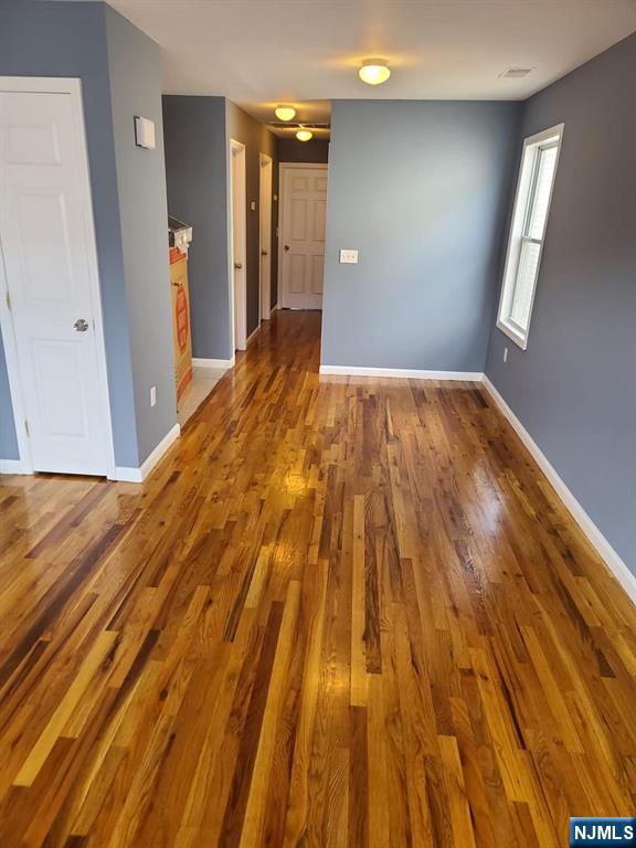 51 Godwin Avenue Paterson, NJ 07501 - Photo 7 of 14 a view of empty room with window and wooden floor