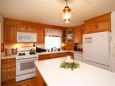 120 Hay Road Eastham, MA 02642 - Photo 5 of 25 a kitchen with a refrigerator and a stove