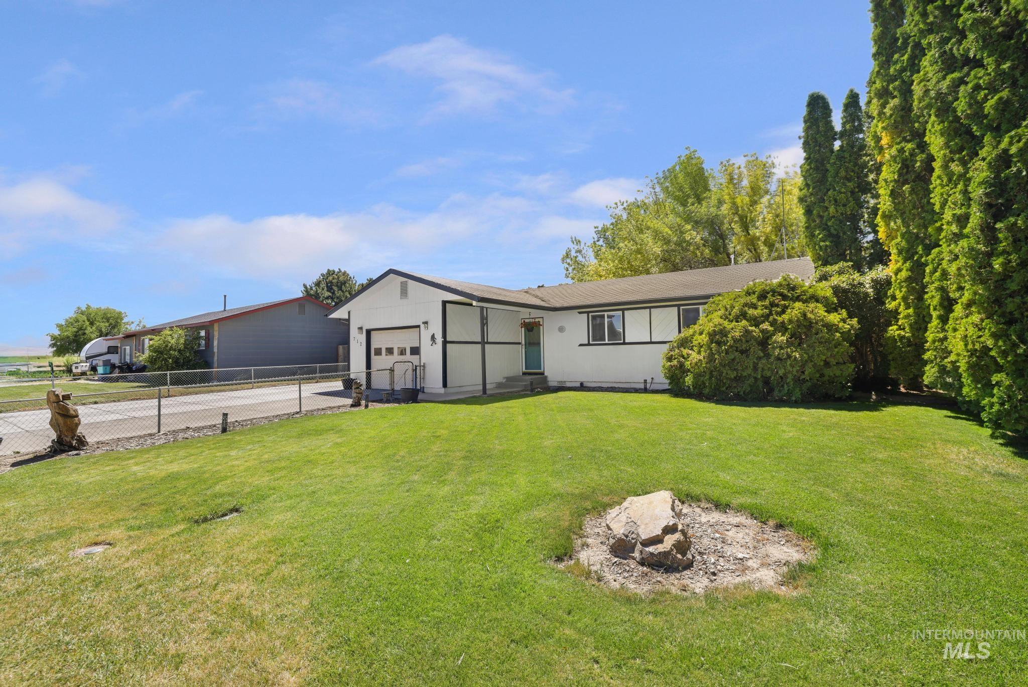712 Locust Street Kimberly, ID 83341 - Photo 25 of 26 Ranch-style residence featuring a white exterior with dark trim, an attached single-car garage, and a covered entry