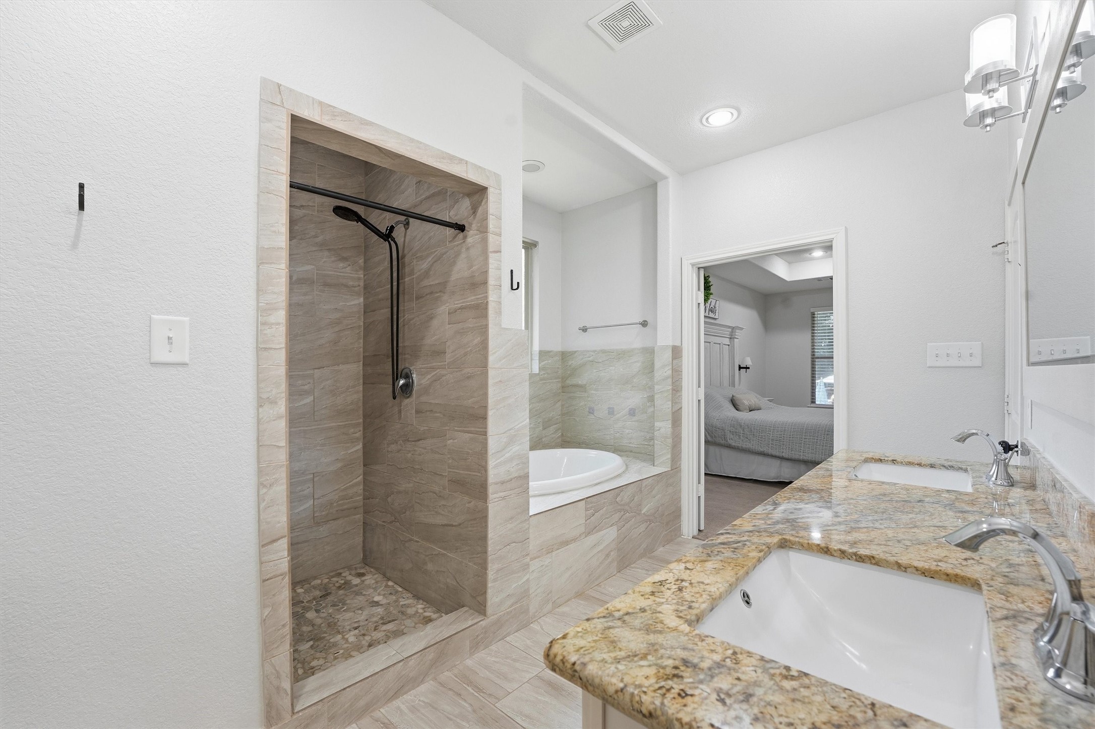 205 Kingspoint Conroe, TX 77356 - Photo 13 of 29 Primary en-suite with dual vanities, separate tub and walk-in shower