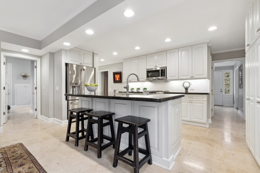 567 Rosemary Road Lake Forest, IL 60045 - Photo 15 of 42 a kitchen with kitchen island granite countertop wooden cabinets and refrigerator