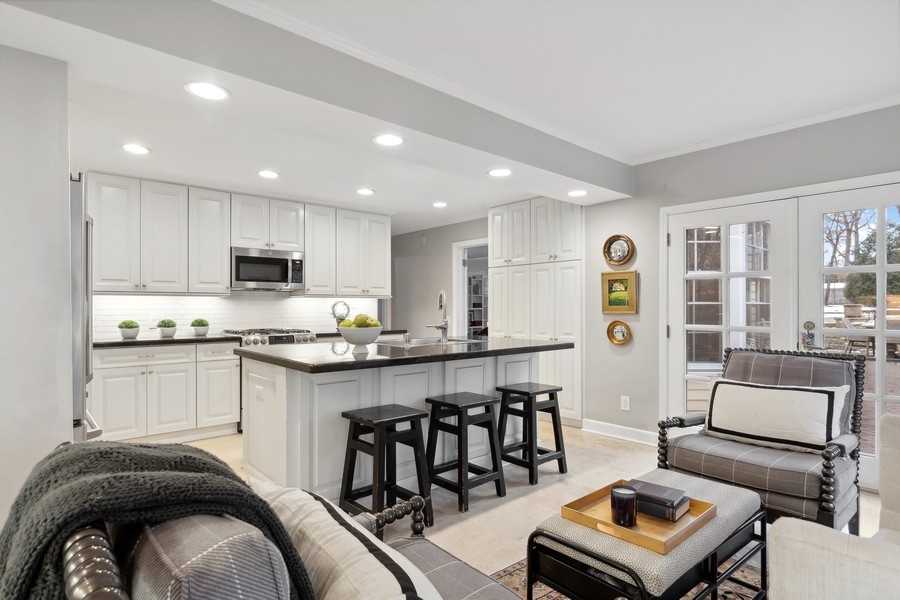 567 Rosemary Road Lake Forest, IL 60045 - Photo 17 of 42 a kitchen with stainless steel appliances granite countertop a stove a sink a refrigerator white cabinets and couches with wooden floor