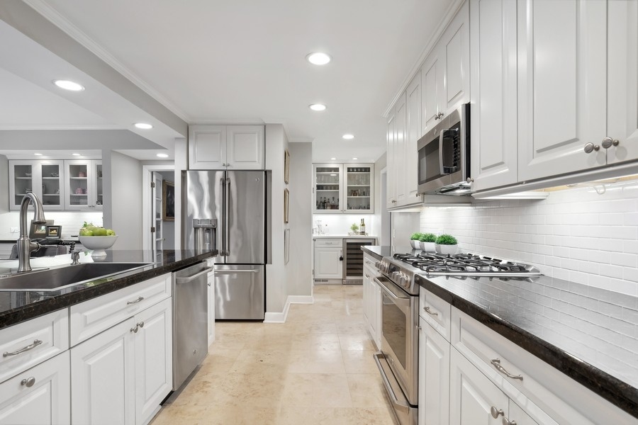 567 Rosemary Road Lake Forest, IL 60045 - Photo 18 of 42 a kitchen with refrigerator and cabinets