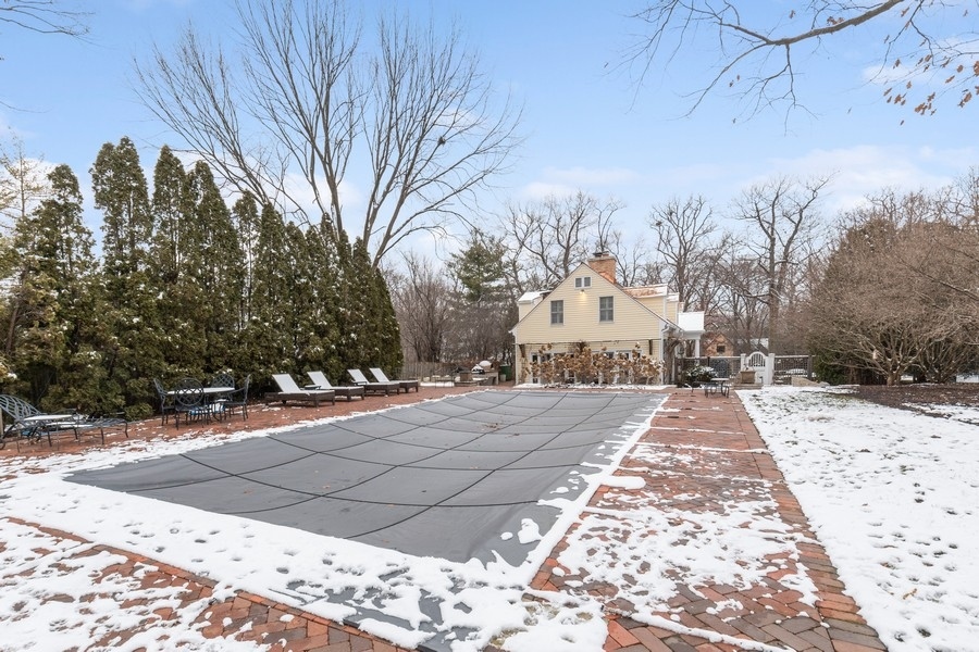 567 Rosemary Road Lake Forest, IL 60045 - Photo 34 of 42 a view of a white house with a snow on the road