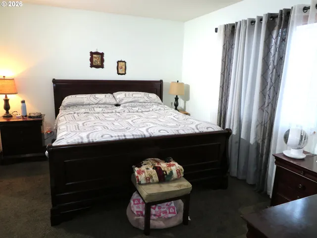 a bedroom with a bed and a mirror