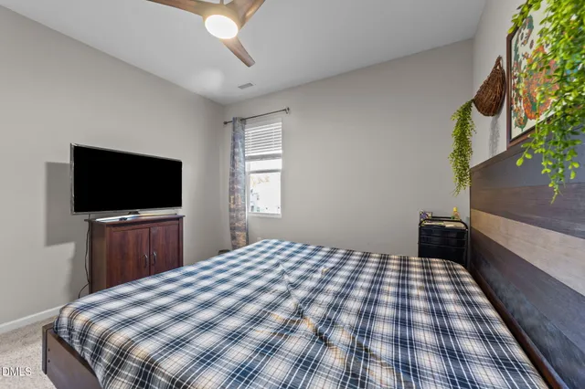 a hallway with white doors wooden floor and stairs