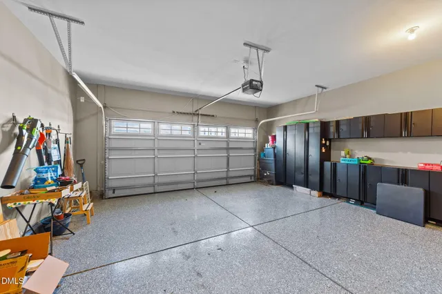 a kitchen with stainless steel appliances kitchen island granite countertop a refrigerator and a stove top oven