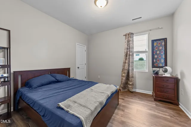 a kitchen with a refrigerator a sink dishwasher and a stove with wooden floor