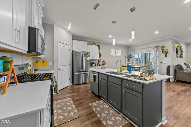 a kitchen with stainless steel appliances granite countertop a sink a stove and a granite counter tops