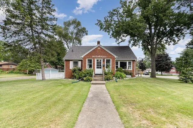 a front view of house with yard and green space