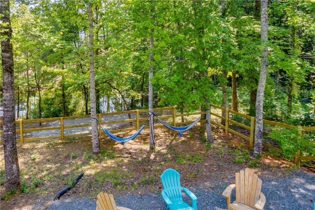 206 Petty Road Seneca, SC 29672 - Photo 44 of 48 Relax in serene outdoor comfort with hammocks nestled amongst the trees, overlooking a tranquil water view.