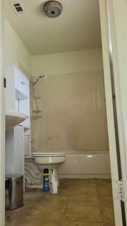 902 South Old Temple Road Hewitt, TX 76643 - Photo 21 of 32 Bathroom featuring a white bathtub, toilet, and wall-mounted sink