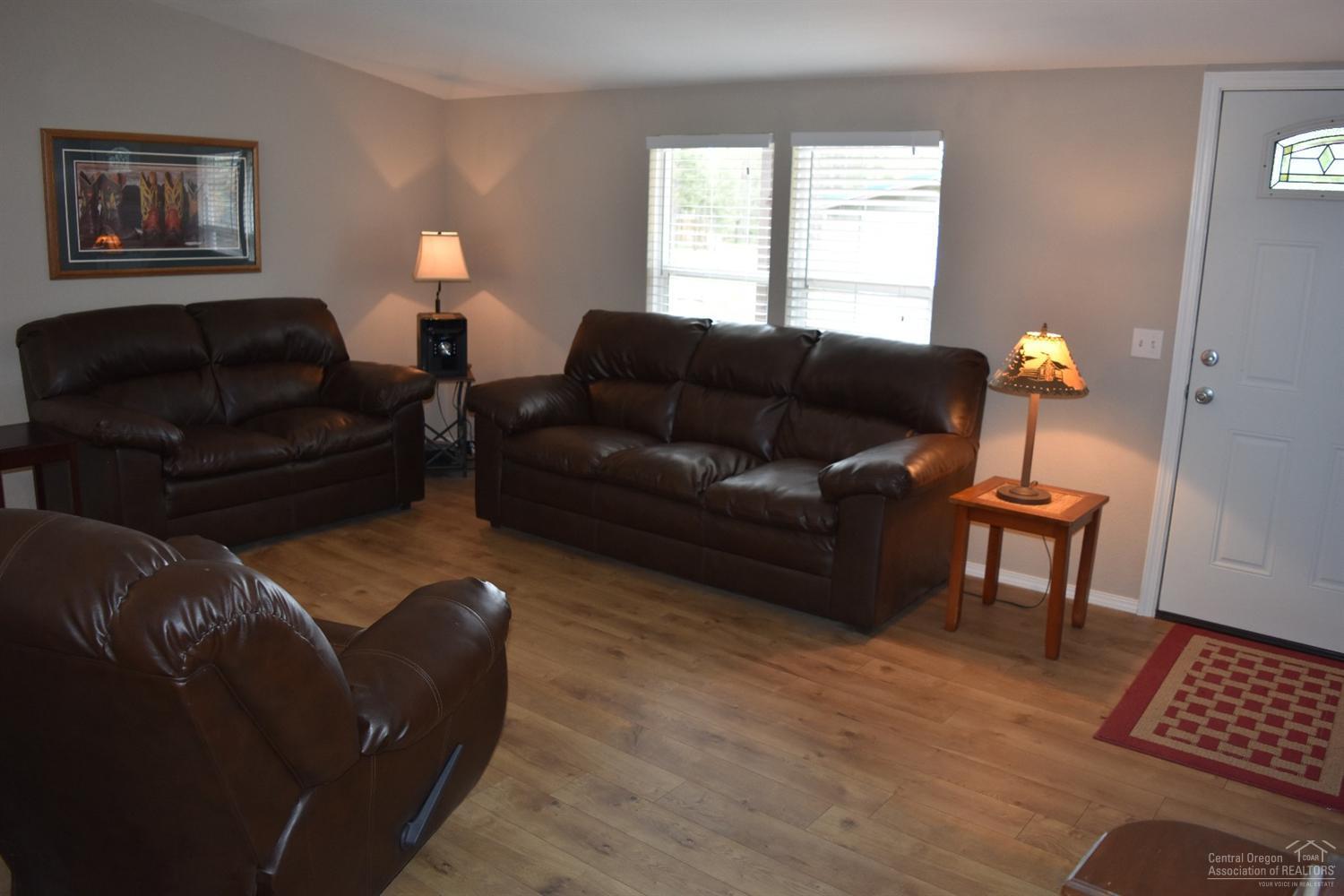 56045 Black Duck Road Bend, OR 97707 - Photo 9 of 22 a living room with furniture a couch and a window