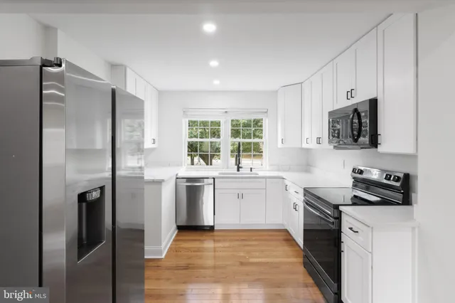 a kitchen with a refrigerator stove and microwave
