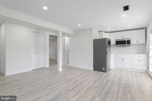 a view of kitchen with stainless steel appliances refrigerator microwave and stove