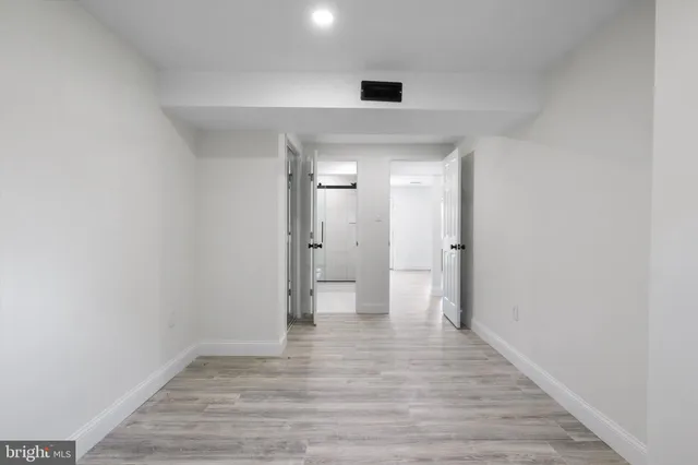 a view of an empty room and wooden floor