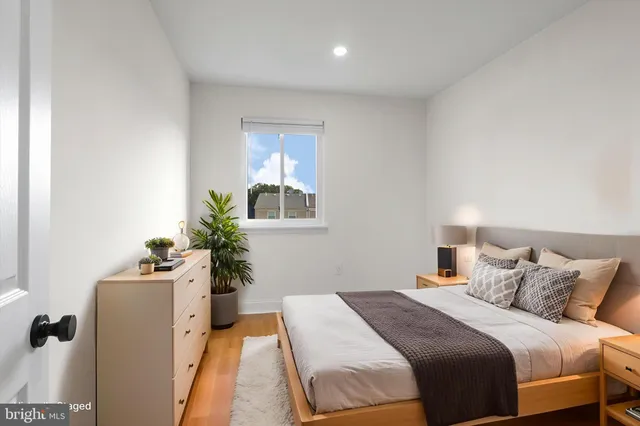 a bedroom with a bed and a potted plant
